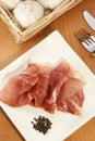 ham on a white plate with fork and knife Royalty Free Stock Photo