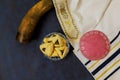 Hamantaschen cookies, carnival mask, noisemakers symbolize a Jewish Purim holiday