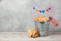 Hamantaschen cookies or hamans ears in bucket over rustic background for Jewish holiday Purim