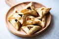 Hamantashen cookies on a wooden board on a gray background. Close up