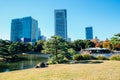 Hamarikyu Gardens, pond and modern buildings at autumn in Tokyo, Japan