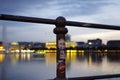 Hamburg Binnenalster at night with a railing and the department store `Alsterhaus` and fountain in the background, Picture was t Royalty Free Stock Photo