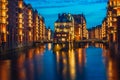 Hamburg city old port in blue hour, Germany, Europe. Historical famous warehouse district with illuminated water castle