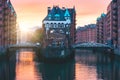 Hamburg city old port, Germany, Europe. Historical famous warehouse district with water castle palace at sunset golden