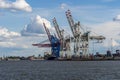 Hamburg container port with some ships loading and cranes loading ships, Germany