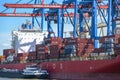 Hamburg, Germany, August 3, 2022: Large container cargo ship moored at a terminal with cranes in the industrial port of Hamburg. Royalty Free Stock Photo