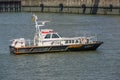 Hamburg, Germany, August 3, 2022: Pilot boat Lotse 3 in front of the quay in the cargo port on the river Elbe, copy space in the Royalty Free Stock Photo