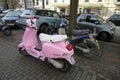 Vespa scooter light pink, side view, parked on the roadside in Hamburg