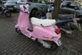 Vespa scooter light pink, side view, parked on the roadside in Hamburg