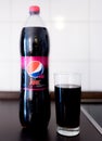 Hamburg, Germany 01.18.2018 illustrative editorial PET bottle of Pepsi Max Cherry with filled drinking glass on kitchen counter
