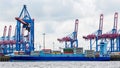 Side view of a container ship anchoring at a container terminal Royalty Free Stock Photo