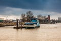 Ferry navigating on the Elbe river in a cold cloudy winter day in Hamburg Royalty Free Stock Photo