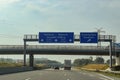 View at traffic signs on the german Highway called A7 from inside a car