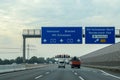 View at traffic signs on the german Highway called A7 from inside a car