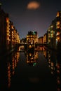 Hamburg, Germany. View of Wandrahmsfleet at dusk illumination light with reflection in the water. Located in Warehouse