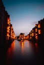 Hamburg, Germany. View of Wandrahmsfleet during sunset with illuminated buildings. Warehouse Landmark District -