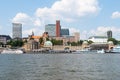 Waterside view of famous St. Pauli Piers and River Elbe against blue summer sky