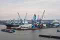 Hamburg. View of the city port with ships and docks, cargo cranes and warehouses Royalty Free Stock Photo