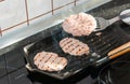 Hamburger being cooked on the griddle