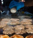 Hamburger being grilled over a wood fire