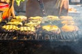 Hamburger being grilled over a wood fire