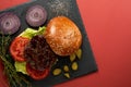 Hamburger on a black board flatlay.