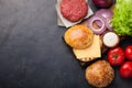 Hamburger Building Kit. Fresh ingredients for Burger on dark stone table. Top view with copy space Royalty Free Stock Photo
