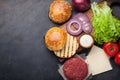 Hamburger Building Kit. Fresh ingredients for Burger on dark stone table. Top view with copy space Royalty Free Stock Photo