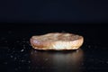 Burger bun on a black background. Lower half burger bun