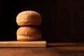 Hamburger buns. Sesame seeds on top. Wooden background. Food concept. Place for text Royalty Free Stock Photo