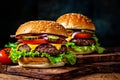 Hamburger. Cheese burger - American cheese burger with Golden French fries and ketchup. Big tasty hamburger with meat, cheese. Royalty Free Stock Photo