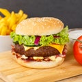 Hamburger Cheeseburger fastfood fast food with French Fries on a wooden board square Royalty Free Stock Photo