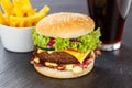 Hamburger Cheeseburger meal fastfood fast food with cola drink and French Fries on a slate Royalty Free Stock Photo