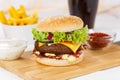 Hamburger Cheeseburger meal fastfood fast food with cola drink and French Fries on a wooden board Royalty Free Stock Photo