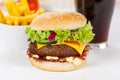 Hamburger Cheeseburger meal fastfood fast food with cola drink and French Fries on a wooden board Royalty Free Stock Photo