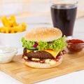 Hamburger Cheeseburger meal fastfood fast food with cola drink and French Fries on a wooden board square Royalty Free Stock Photo