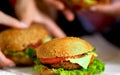 Hamburger fast food with ham on wooden board . Group hamburger.