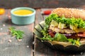 Hamburger with feta cheese and chicken beef on a wooden table. symbol of diet temptation resulting in unhealthy nutrition. place Royalty Free Stock Photo