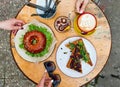 hamburger in the form of a dout, sandwiches, coffee, lots of food on a wooden table Royalty Free Stock Photo