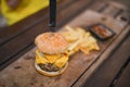 Hamburger, French fries and a Cup of sauce served on a wooden pl Royalty Free Stock Photo