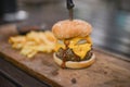 Hamburger, French fries and a Cup of sauce served on a wooden pl Royalty Free Stock Photo