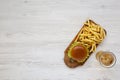 Hamburger, french fries and glass of cold beer on a white wooden surface, top view. Overhead, flat lay, from above. Copy space Royalty Free Stock Photo