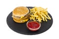 Hamburger and french fries, ketup on black plate Royalty Free Stock Photo