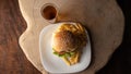 Hamburger and French fries placed on a white plate together with a glass of soft drink on rustic wood with black background, top Royalty Free Stock Photo