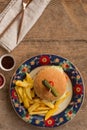 Hamburger with french fries in plate with ornaments