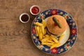 Hamburger with french fries in plate with ornaments