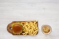 Hamburger, french fries, sauce and glass of cold beer on a white wooden surface, top view. Overhead, flat lay, from above. Copy Royalty Free Stock Photo