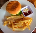 Hamburger and french fries on white plate with sause. Burger top view. Rich nutrititive breakfast. American food Royalty Free Stock Photo