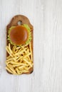 Hamburger and french fries on a white wooden background, top view. Copy space Royalty Free Stock Photo