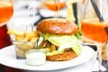 Hamburger with fries on a plate in a beautifully served restaurant. Royalty Free Stock Photo